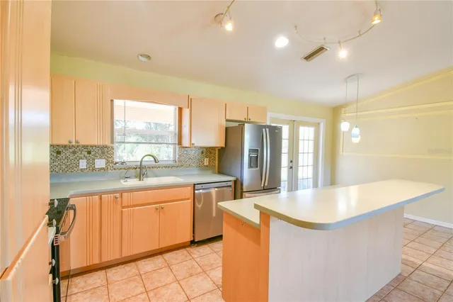 an empty room with a window and ceiling fan