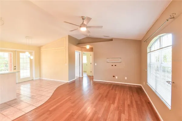 a view of a livingroom with a ceiling fan and wooden floor