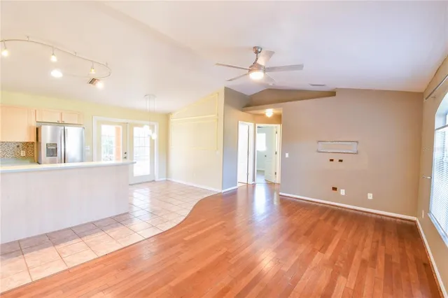 a kitchen with stainless steel appliances kitchen island granite countertop a refrigerator and a stove top oven