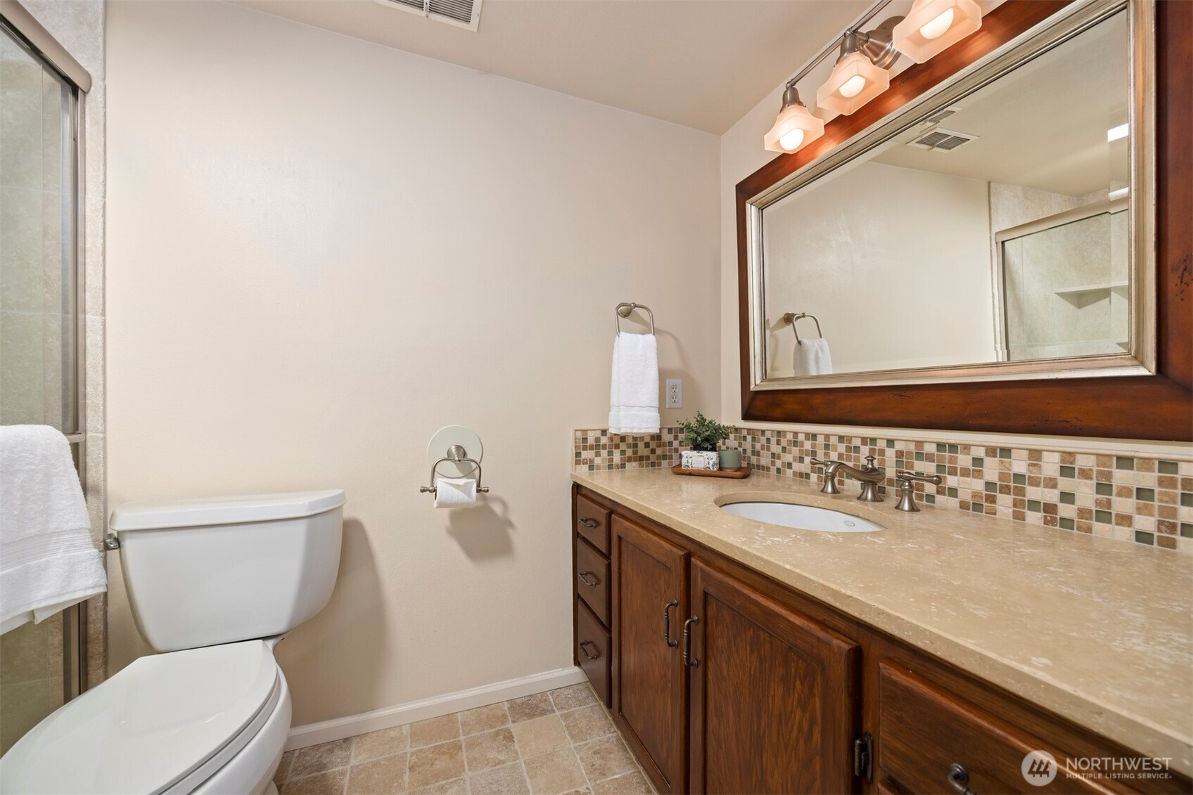 337 South State Street, Unit 2 Bellingham, WA 98225 - Photo 29 of 40 a bathroom with a granite countertop sink mirror vanity and toilet