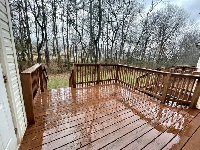 a view of balcony with wooden floor and fence