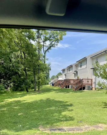 a front view of a house with a yard and trees
