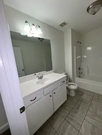 a bathroom with a sink a toilet and bathtub