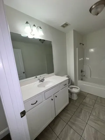 a bathroom with a sink a toilet and bathtub