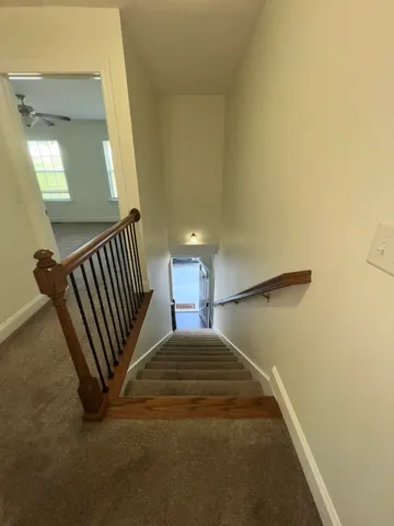 a view of a hallway with staircase