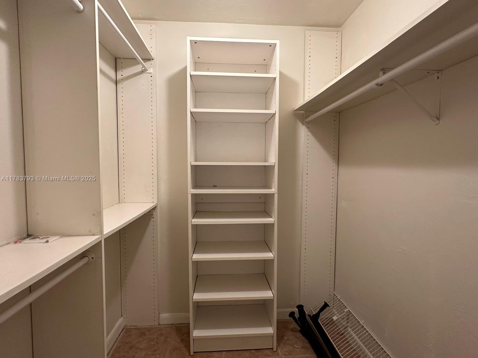 8335 Southwest 72nd Avenue, Unit 202D Miami, FL 33143 - Photo 16 of 24 a view of walk in closet with empty racks