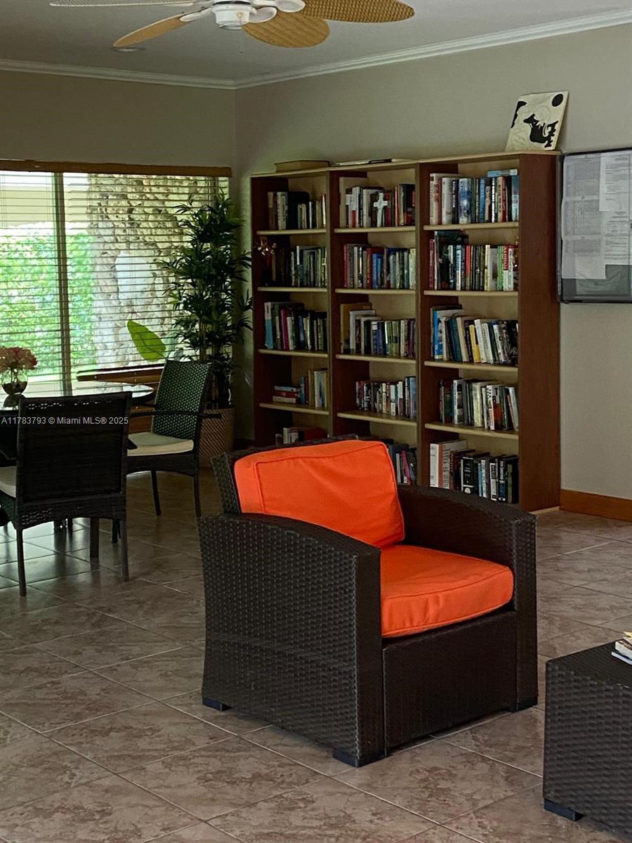 8335 Southwest 72nd Avenue, Unit 202D Miami, FL 33143 - Photo 21 of 24 a living room with couch and a bookshelf