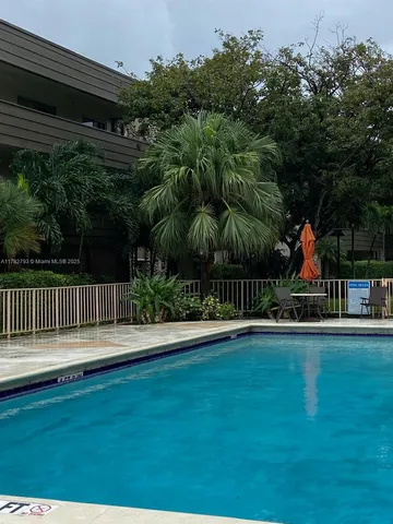 a view of a house with a small yard and plants