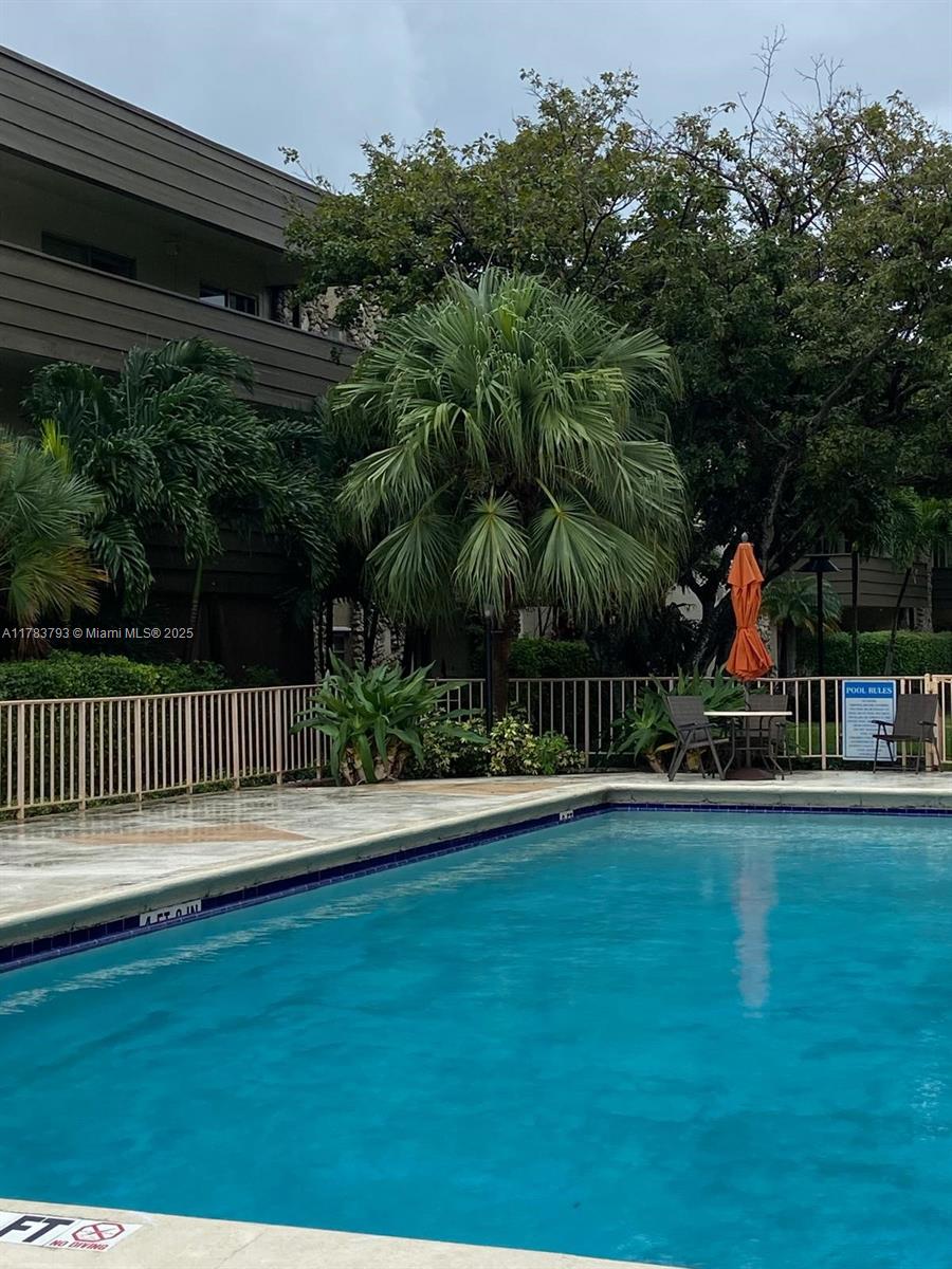 8335 Southwest 72nd Avenue, Unit 202D Miami, FL 33143 - Photo 22 of 24 a view of a swimming pool with a garden