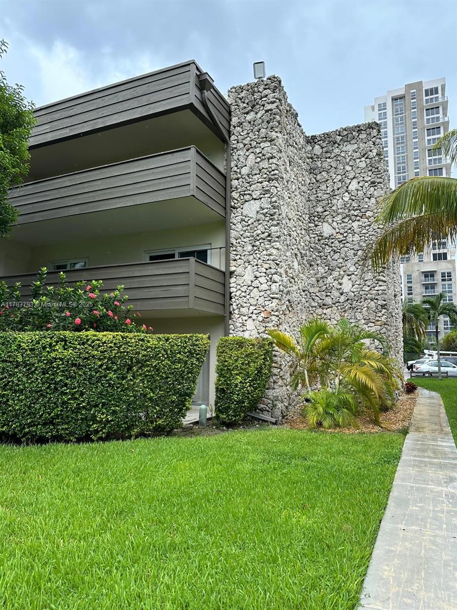 8335 Southwest 72nd Avenue, Unit 202D Miami, FL 33143 - Photo 24 of 24 a view of a house with a small yard and plants