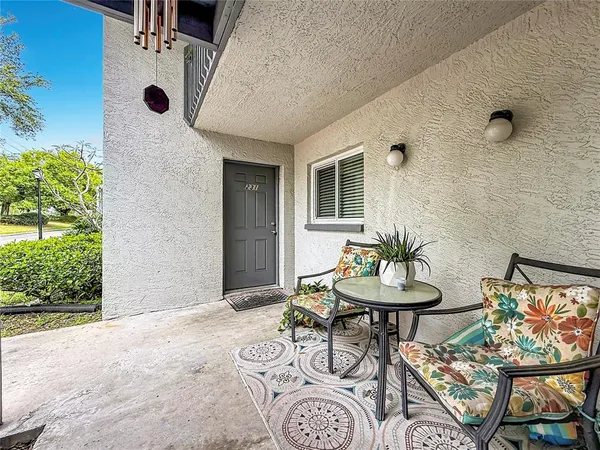 a backyard of a house with table and chairs