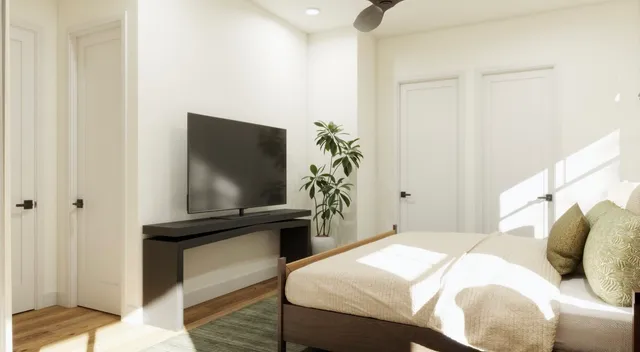 a bedroom with a bed and a flat screen tv