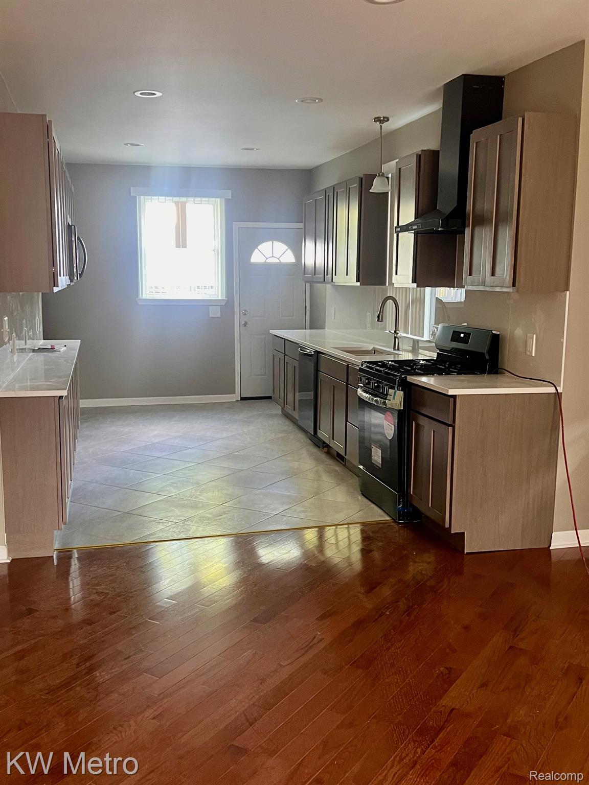 939 Webb Street Detroit, MI 48202 - Photo 2 of 19 Kitchen featuring wood-finish cabinetry, light-colored countertops, a tile backsplash, and recessed lighting