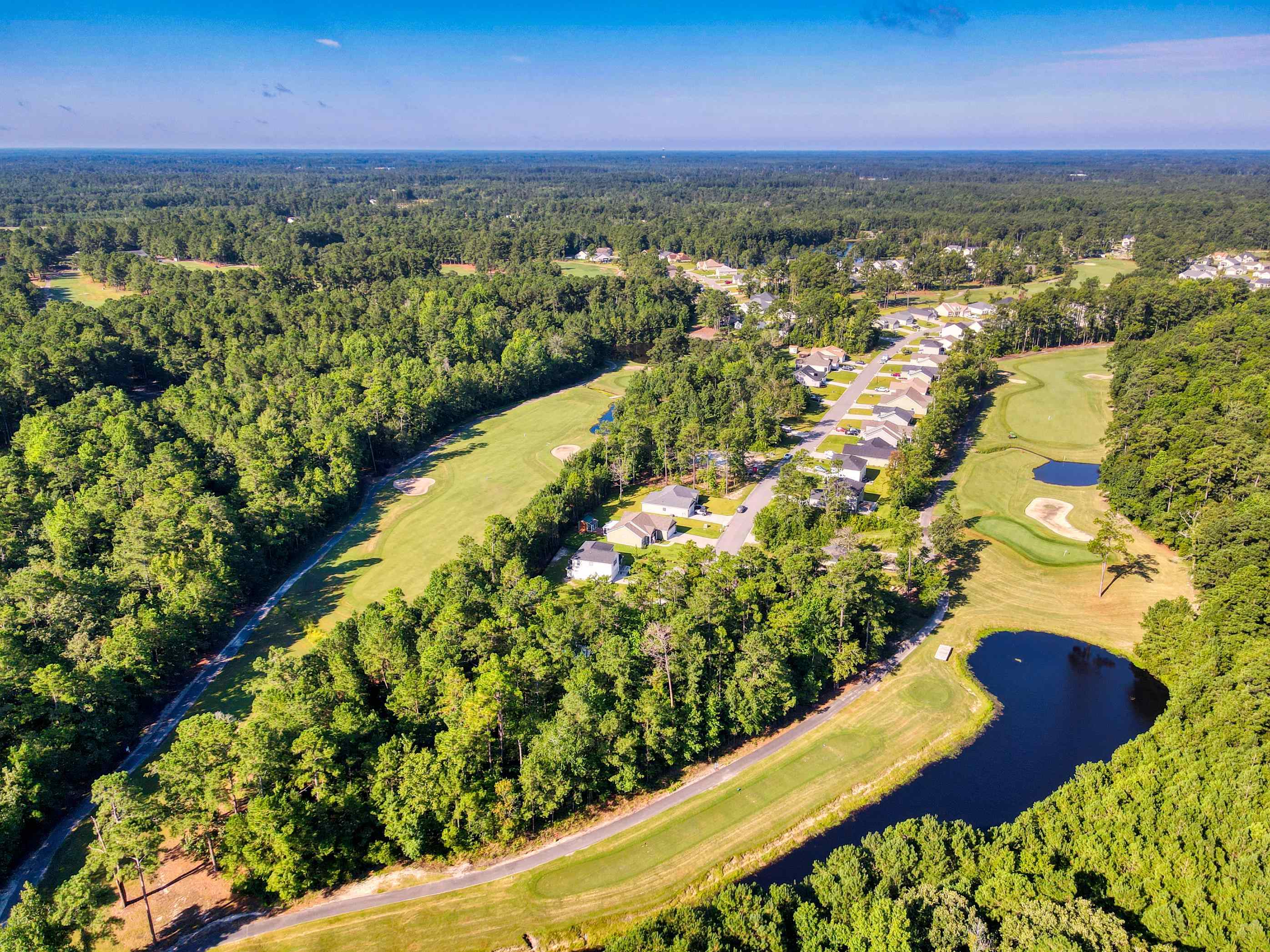 677 Timber Creek Drive Loris, SC 29569 - Photo 14 of 33 Aerial view of property's location featuring a large body of water and a golf course