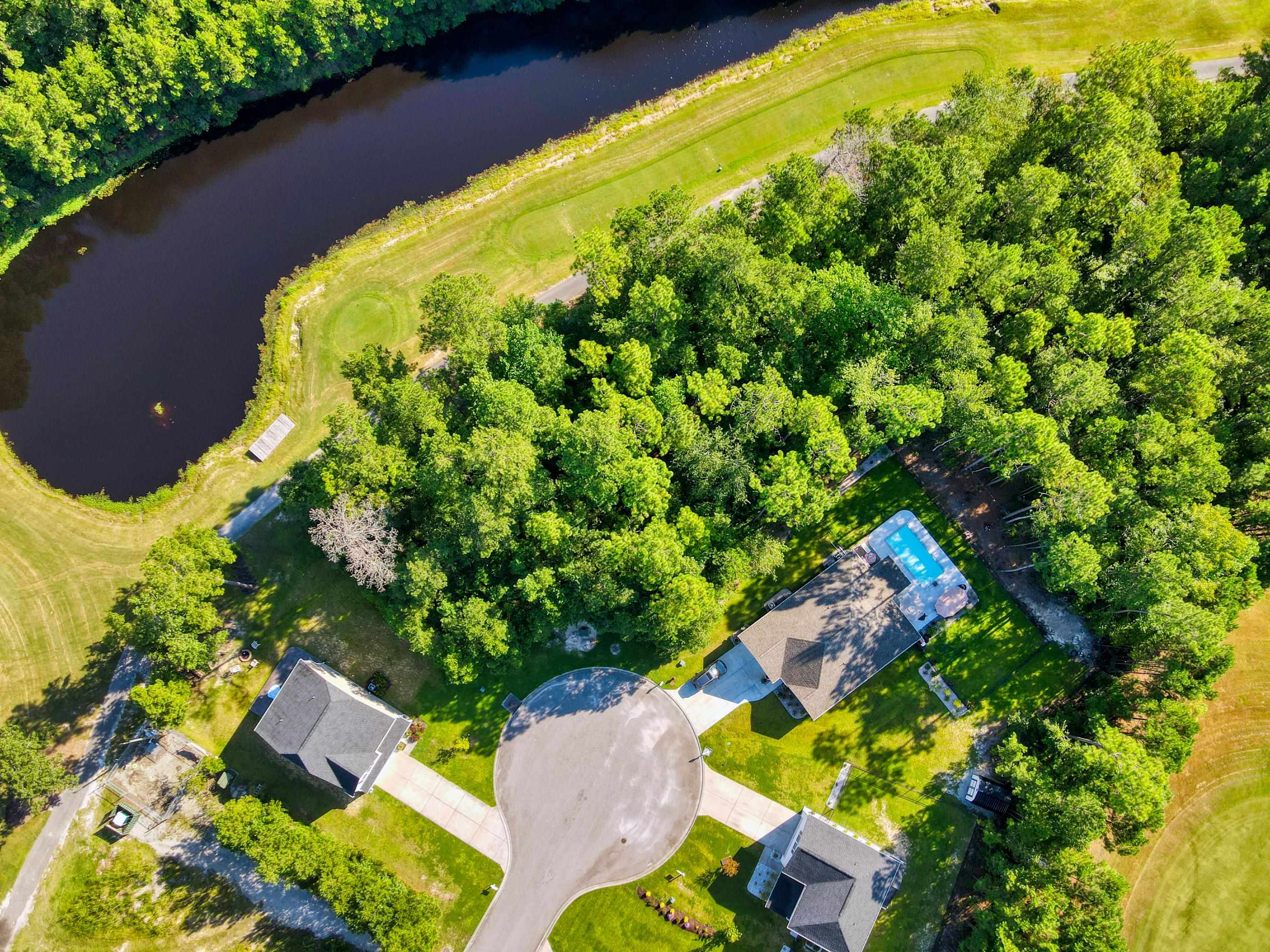 677 Timber Creek Drive Loris, SC 29569 - Photo 22 of 33 Aerial view of property's location with a large body of water and a golf course