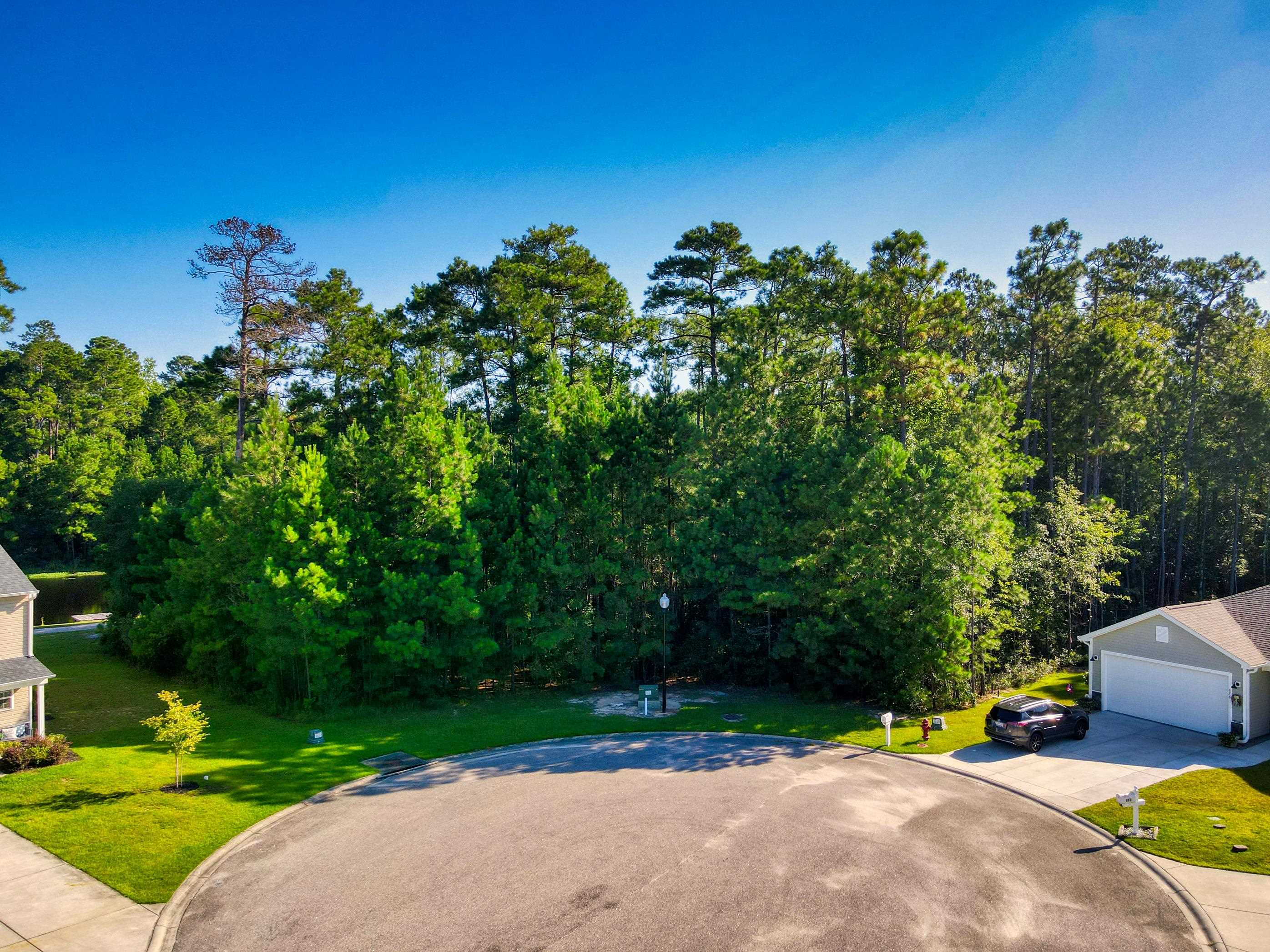 677 Timber Creek Drive Loris, SC 29569 - Photo 32 of 33 Aerial view of property's location with a nearby body of water and nearby suburban area