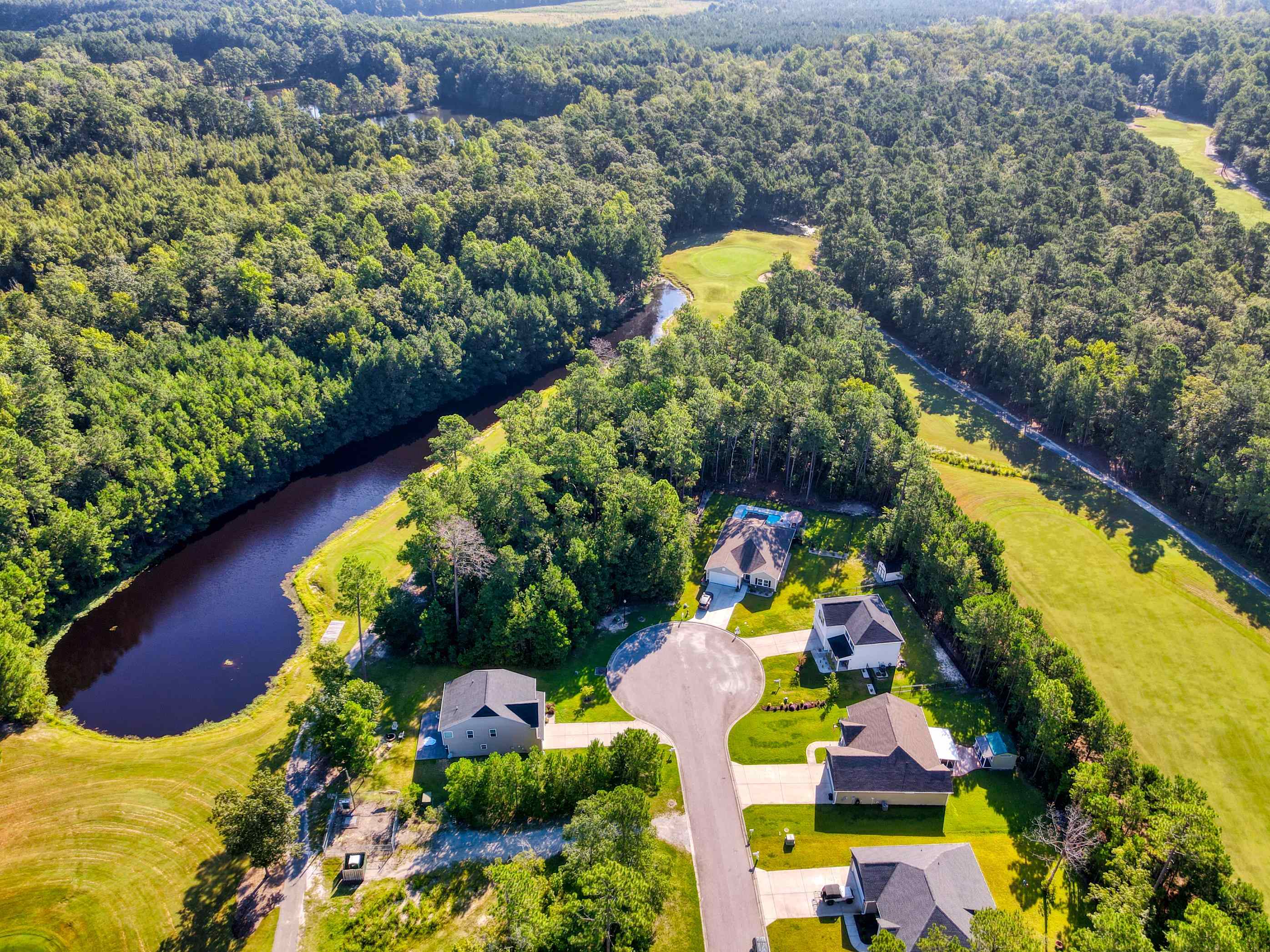 677 Timber Creek Drive Loris, SC 29569 - Photo 10 of 33 Aerial view of property and surrounding area featuring a local golf course and nearby suburban area