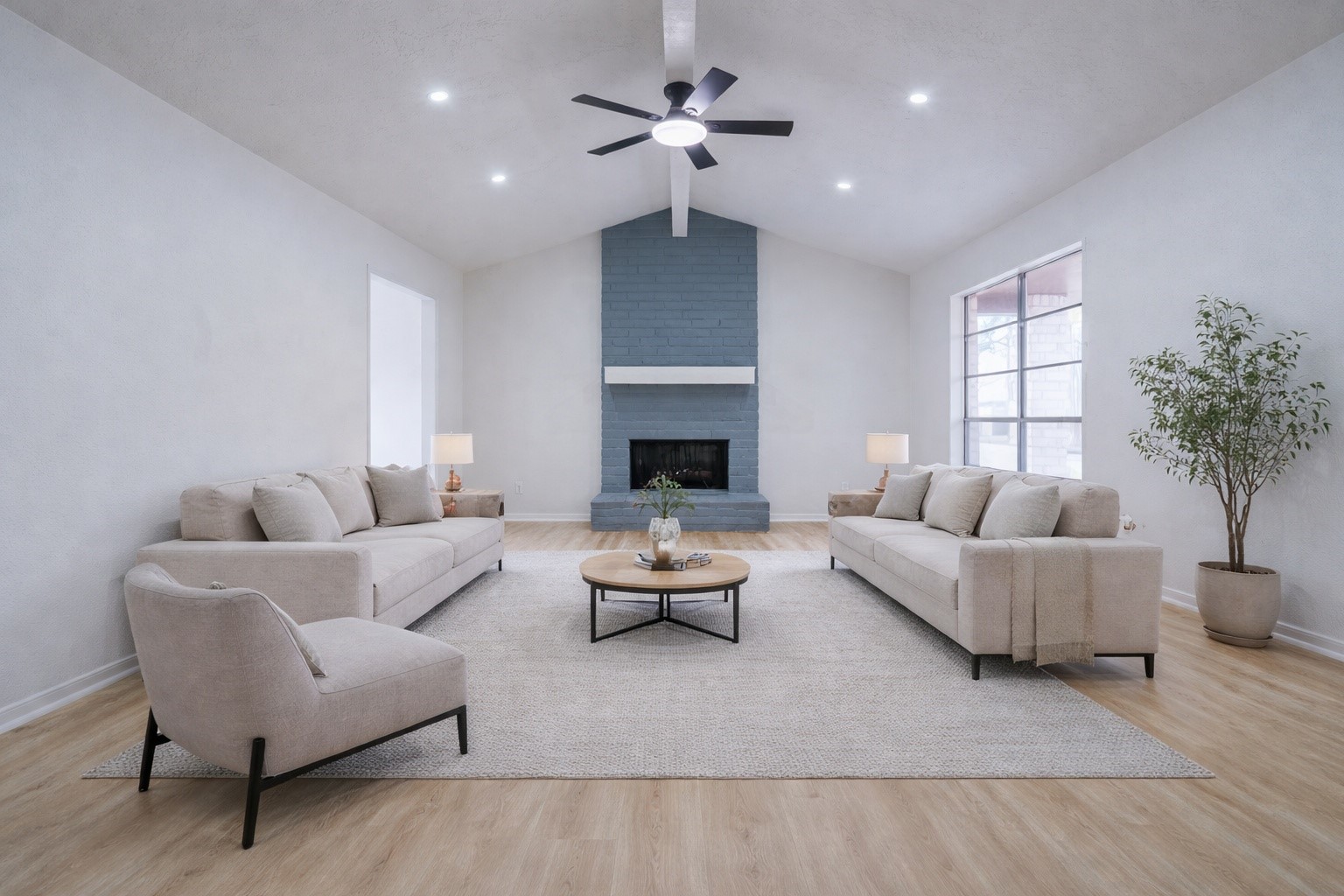 a living room with furniture a chandelier and a fireplace