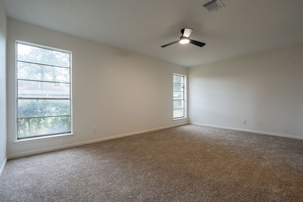 23230 Briarcreek Boulevard Spring, TX 77373 - Photo 13 of 32 an empty room with a window and ceiling fan