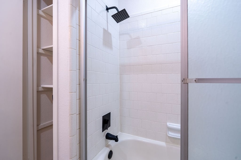 23230 Briarcreek Boulevard Spring, TX 77373 - Photo 22 of 32 a bathroom with a bathtub and shower
