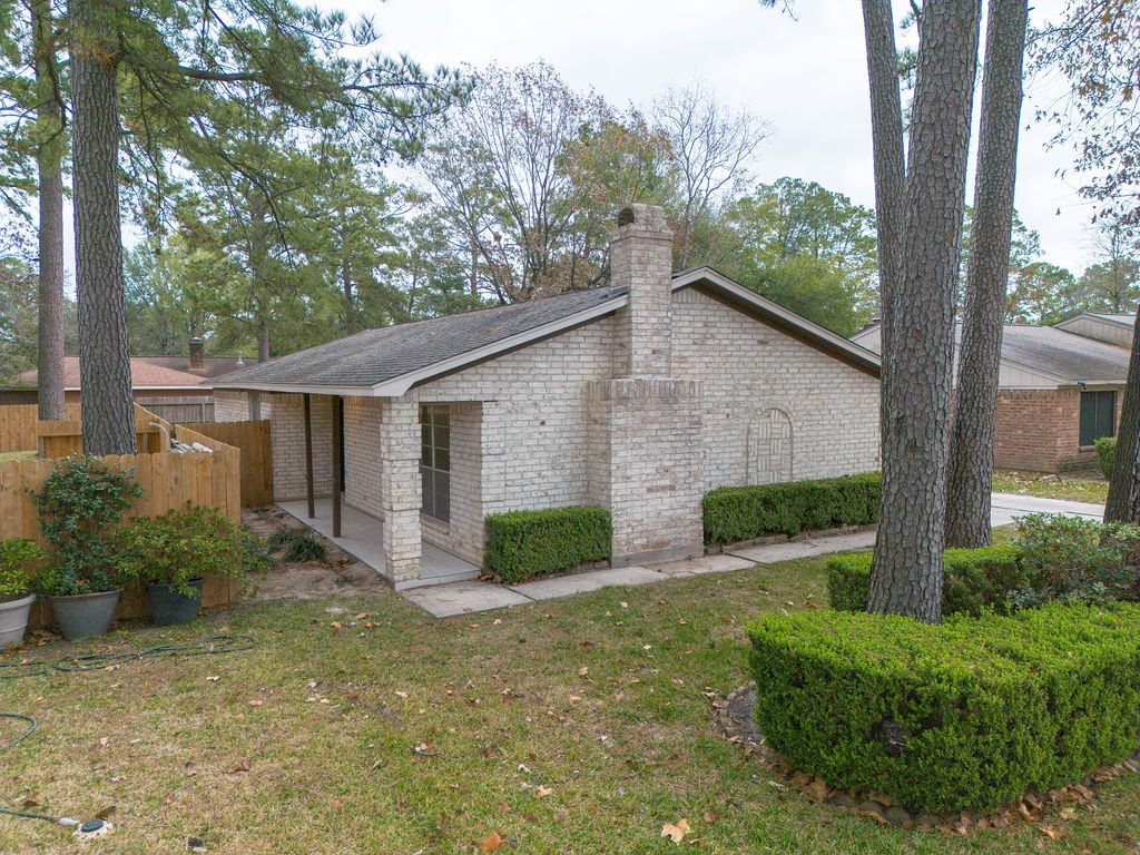 23230 Briarcreek Boulevard Spring, TX 77373 - Photo 30 of 32 a view of a house with a yard and plants