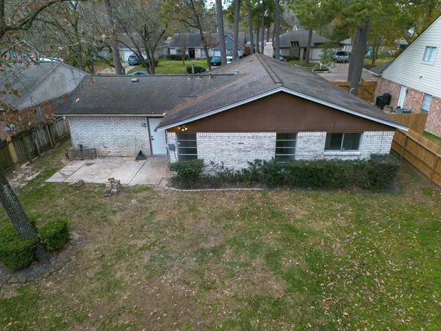 a view of a house with a yard and sitting area