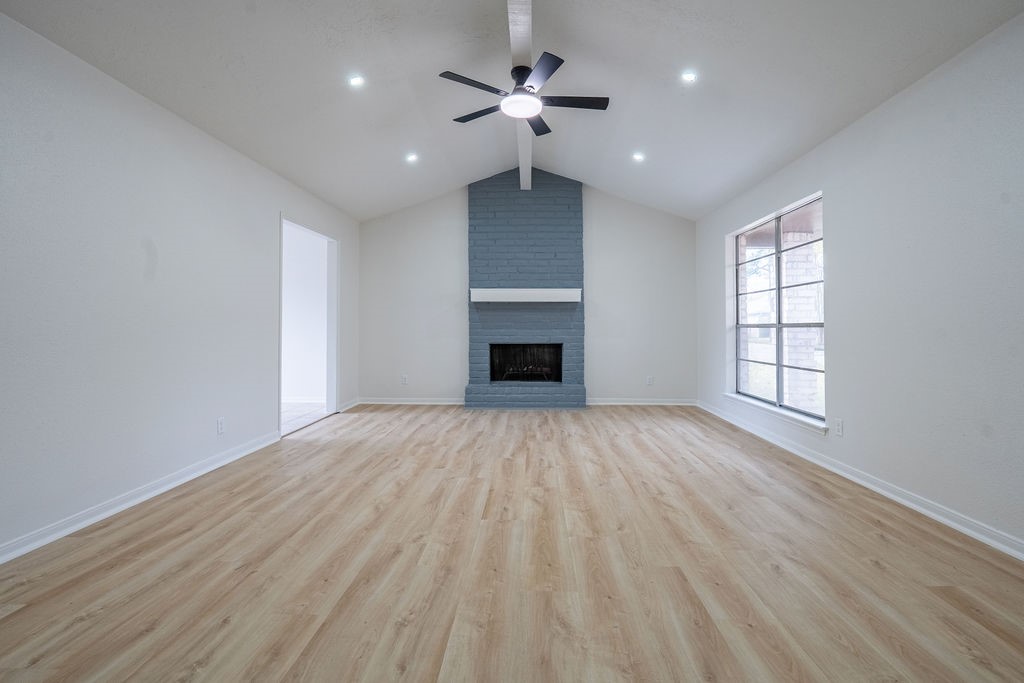 23230 Briarcreek Boulevard Spring, TX 77373 - Photo 7 of 32 wooden floor in an empty room with a window