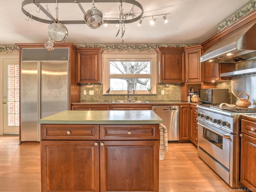 321 Gouges Branch Road Leicester, NC 28748 - Photo 16 of 48 a kitchen with kitchen island a counter top space a sink stainless steel appliances and cabinets