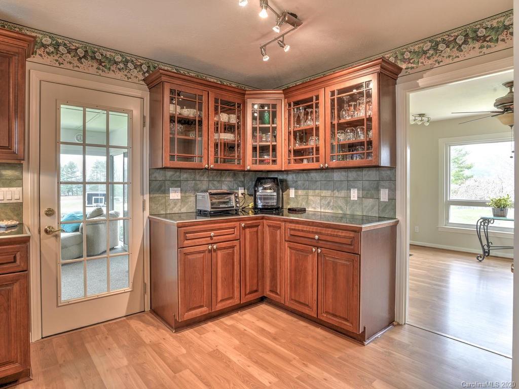 321 Gouges Branch Road Leicester, NC 28748 - Photo 17 of 48 a kitchen with stainless steel appliances granite countertop a stove and a sink