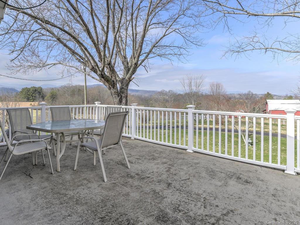 321 Gouges Branch Road Leicester, NC 28748 - Photo 19 of 48 a view of a chairs and deck in the backyard
