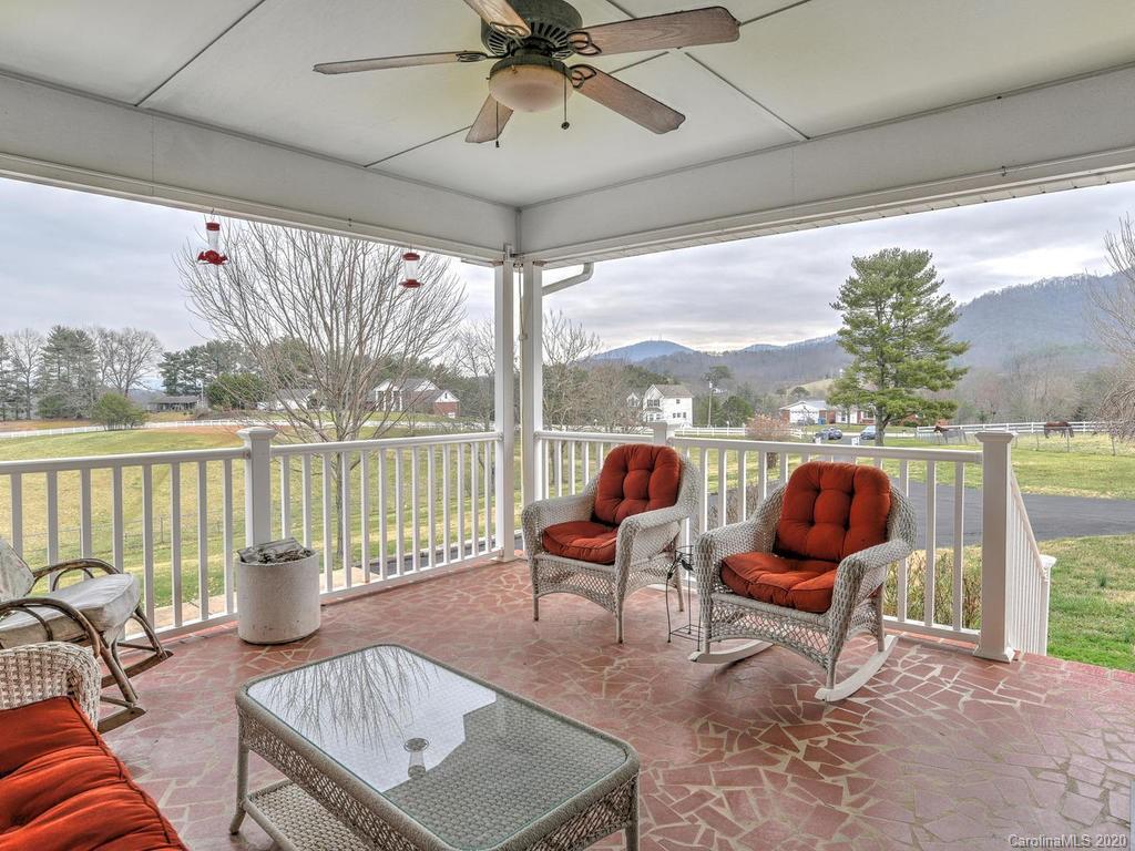 321 Gouges Branch Road Leicester, NC 28748 - Photo 21 of 48 a living room with furniture and a floor to ceiling window