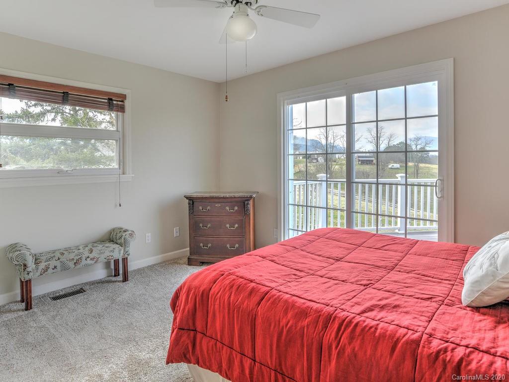 321 Gouges Branch Road Leicester, NC 28748 - Photo 23 of 48 a bedroom with a bed and a table