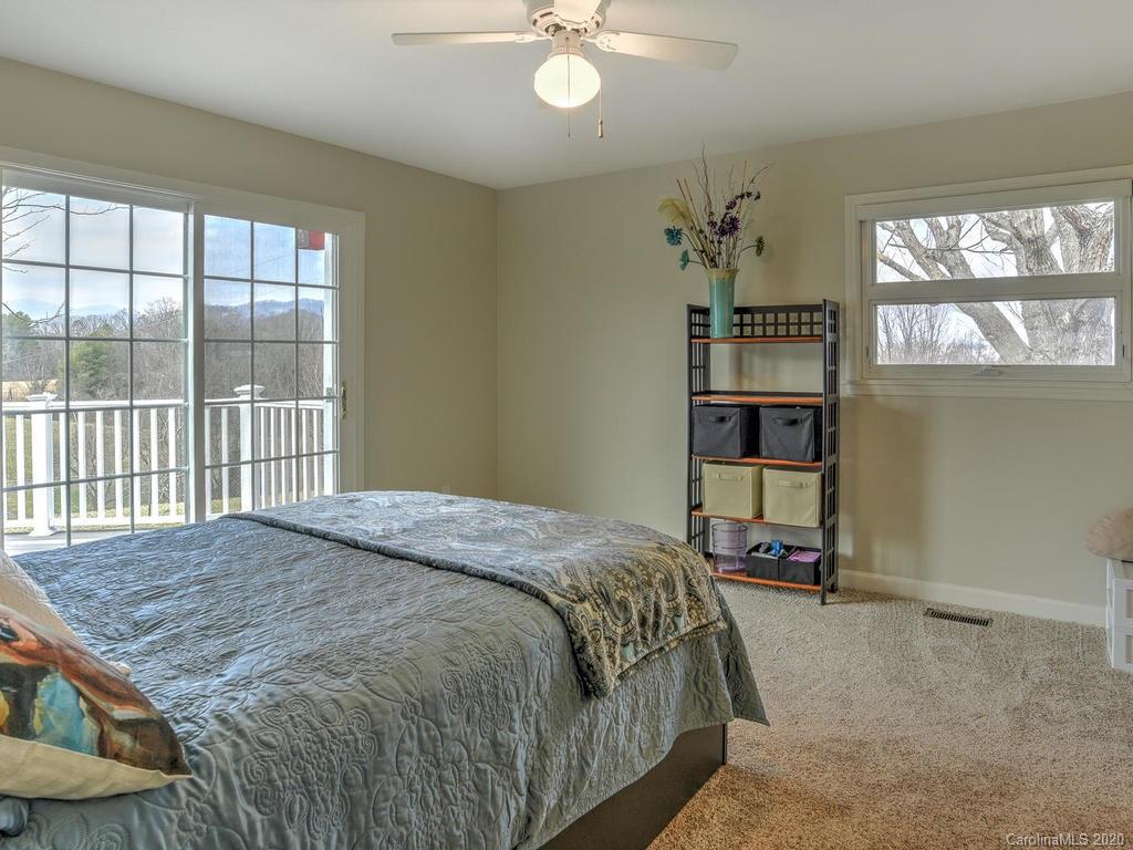 321 Gouges Branch Road Leicester, NC 28748 - Photo 24 of 48 a bedroom with a bed and a window