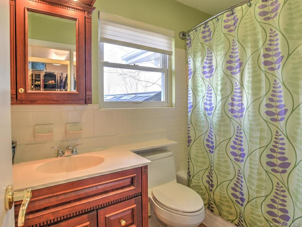 321 Gouges Branch Road Leicester, NC 28748 - Photo 29 of 48 a bathroom with a sink a toilet and a shower curtain
