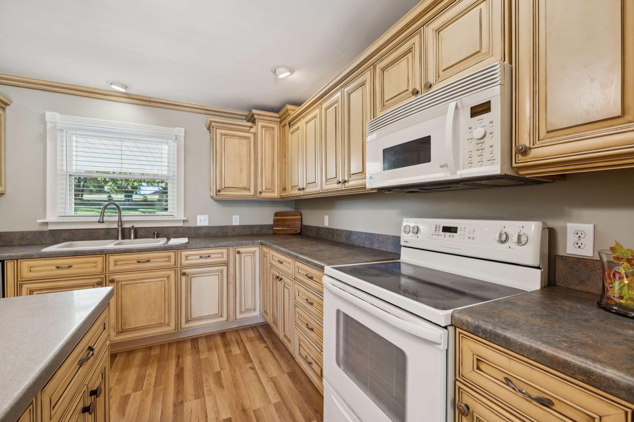 10446 Bold Springs Road McEwen, TN 37101 - Photo 15 of 54 a kitchen with stainless steel appliances granite countertop a sink and dishwasher a stove top oven with wooden floor