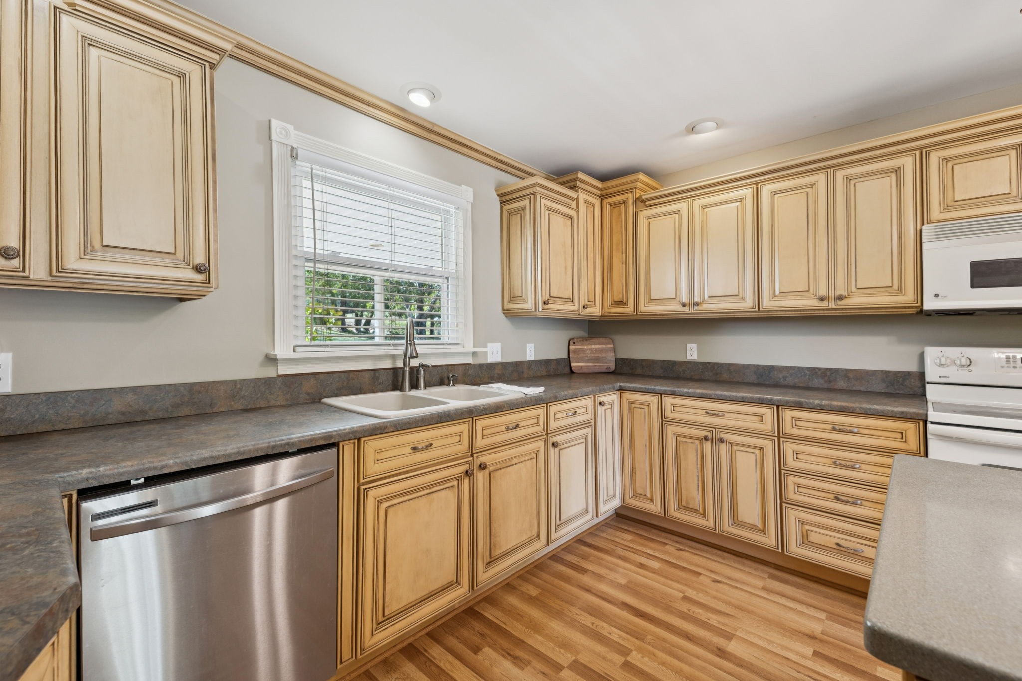 10446 Bold Springs Road McEwen, TN 37101 - Photo 17 of 54 a kitchen with stainless steel appliances granite countertop a sink stove and cabinets