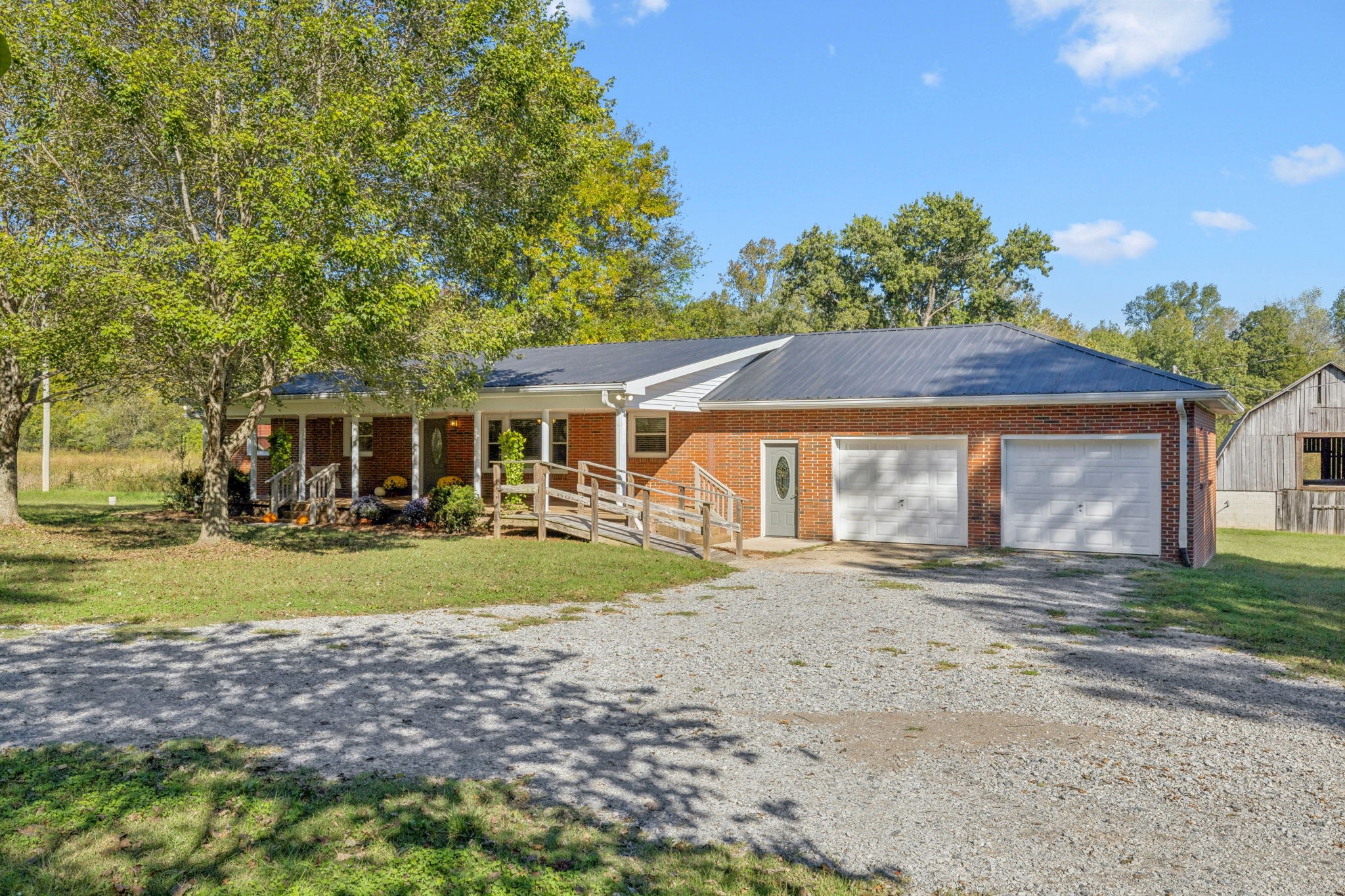 10446 Bold Springs Road McEwen, TN 37101 - Photo 2 of 54 a front view of a house with a yard and garage