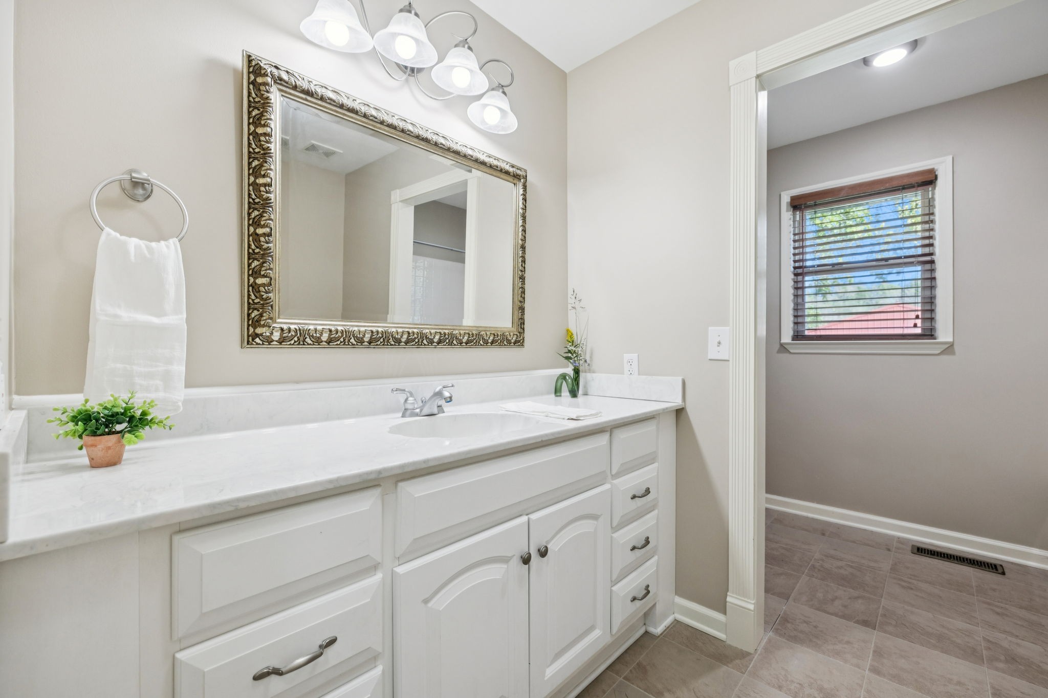 10446 Bold Springs Road McEwen, TN 37101 - Photo 25 of 54 a bathroom with a sink vanity and mirror