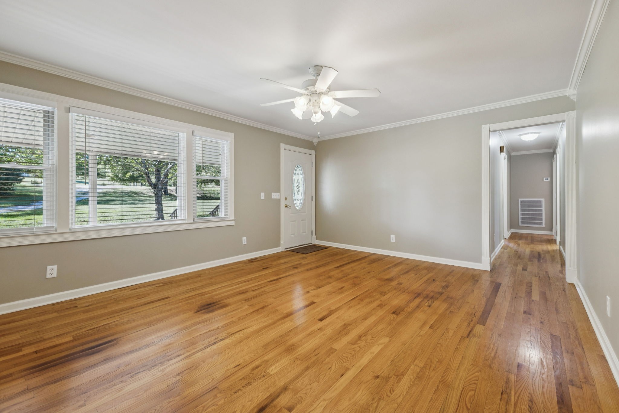 10446 Bold Springs Road McEwen, TN 37101 - Photo 9 of 54 a view of an empty room with wooden floor and a window