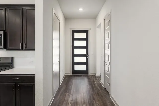 a view of hallway with wooden floor