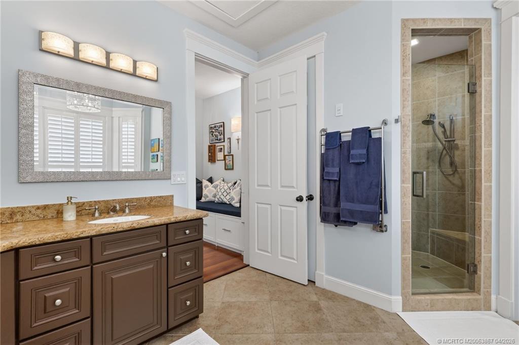 334 Southwest Atlanta Avenue Stuart, FL 34994 - Photo 31 of 56 a spacious bathroom with a shower sink and mirror