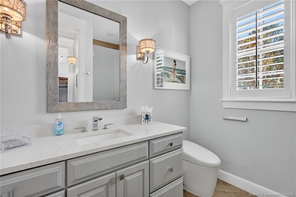 334 Southwest Atlanta Avenue Stuart, FL 34994 - Photo 35 of 56 a bathroom with a toilet sink and mirror