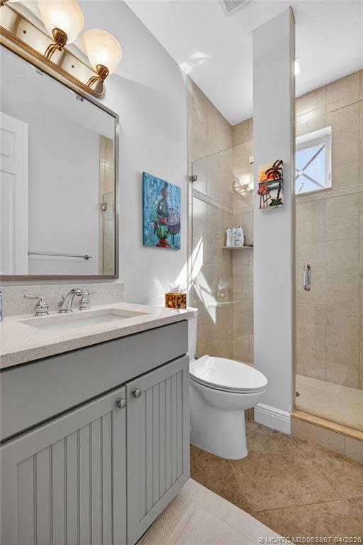 334 Southwest Atlanta Avenue Stuart, FL 34994 - Photo 36 of 56 a bathroom with a sink toilet and shower