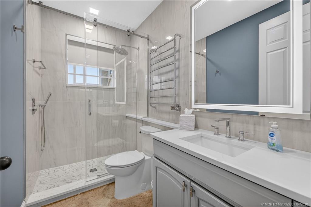 334 Southwest Atlanta Avenue Stuart, FL 34994 - Photo 42 of 56 a bathroom with a sink a toilet and shower