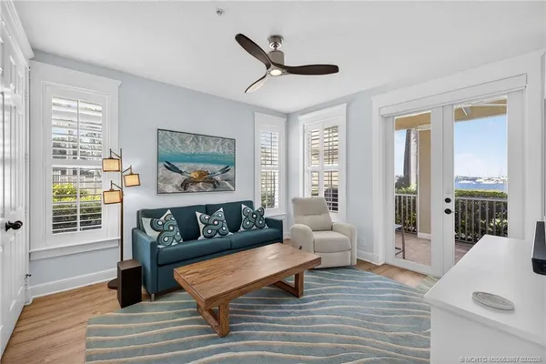 a living room with furniture and a floor to ceiling window