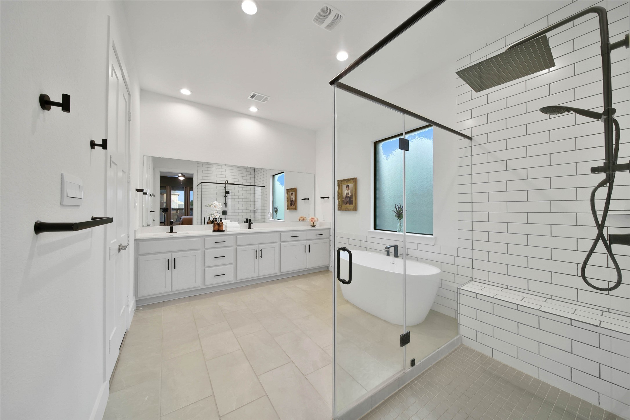 1015 Oak Briar Lane Conroe, TX 77384 - Photo 28 of 50 a bathroom with a double vanity sink mirror and bathtub