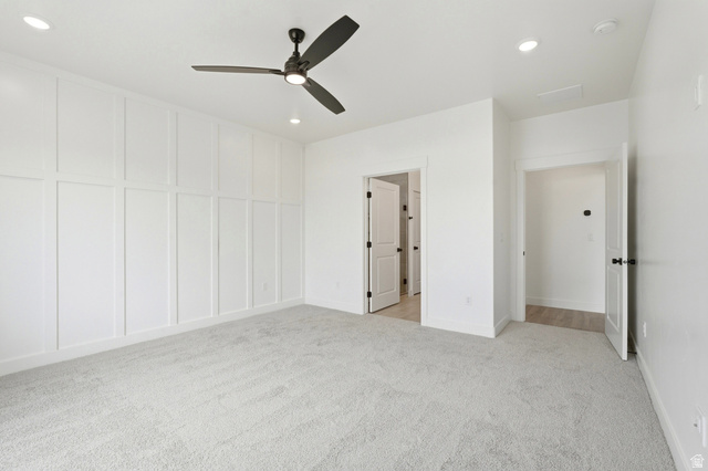 401 West 3085 South, Unit 329 Nibley, UT 84321 - Photo 21 of 34 Unfurnished bedroom with light carpet, a ceiling fan, recessed lighting, and a decorative wall