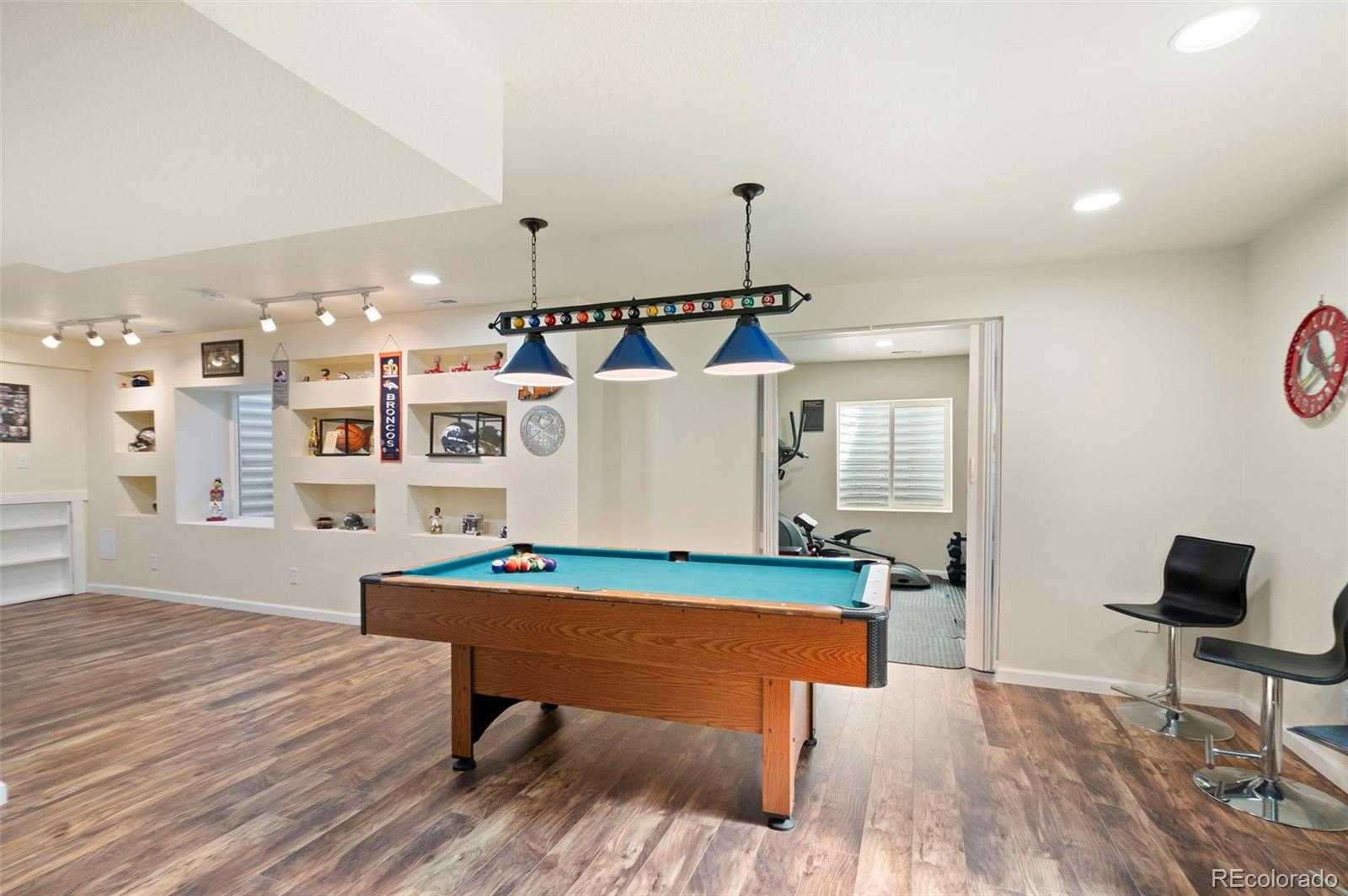 11778 Oneida Street Thornton, CO 80233 - Photo 18 of 30 a living room with a table chairs and wooden floor