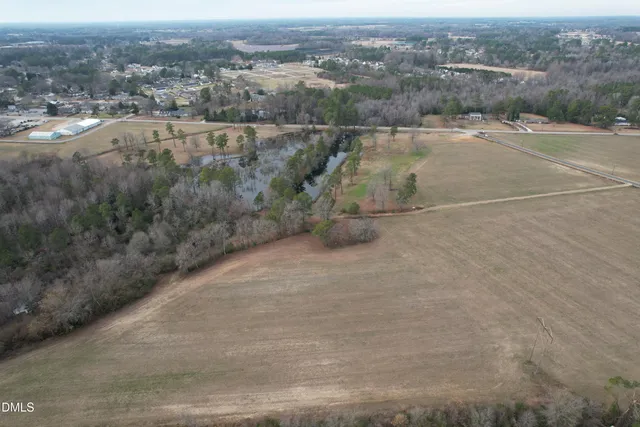an aerial view of residential houses with outdoor space and river