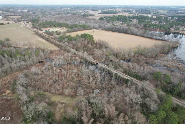an aerial view of a houses with a yard